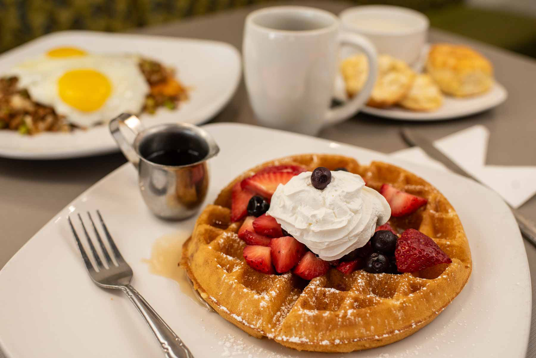 Waffles and Fruit with whipped cream. Plus, coffee and a plate of "trash" and biscuits and gravy.